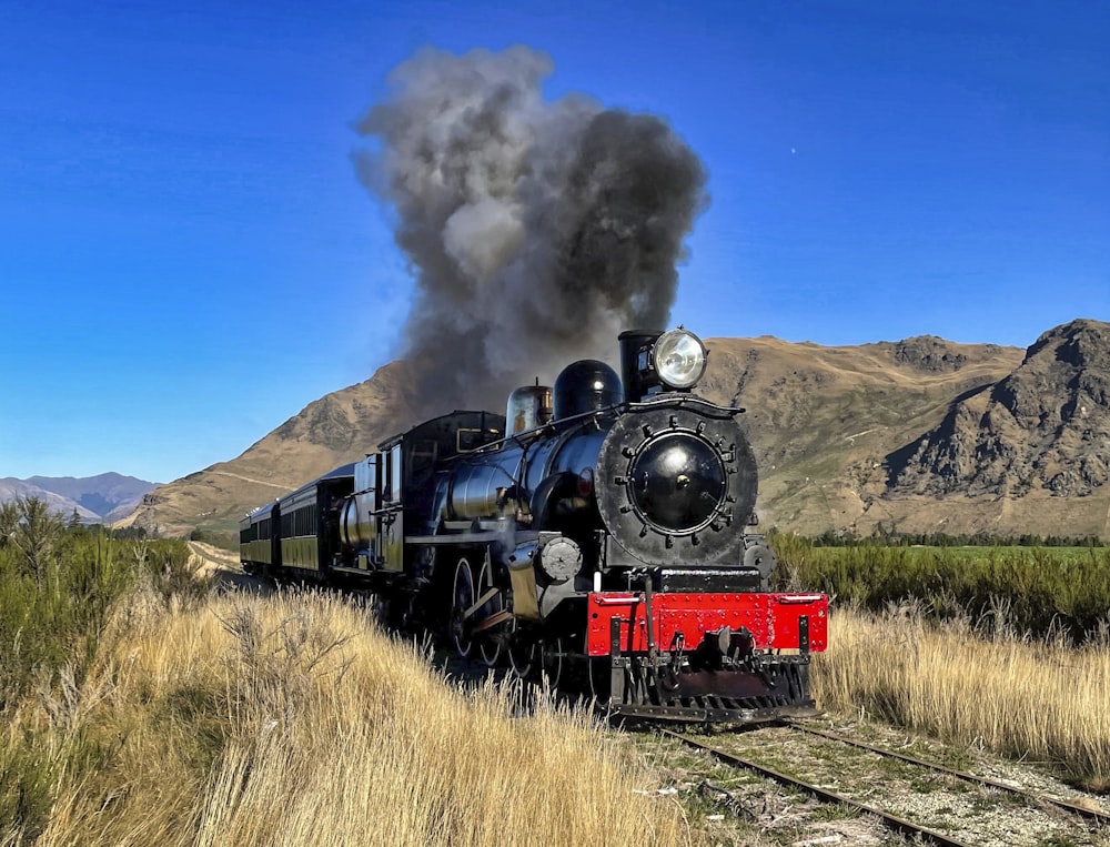 a steam engine train traveling through a rural countryside
