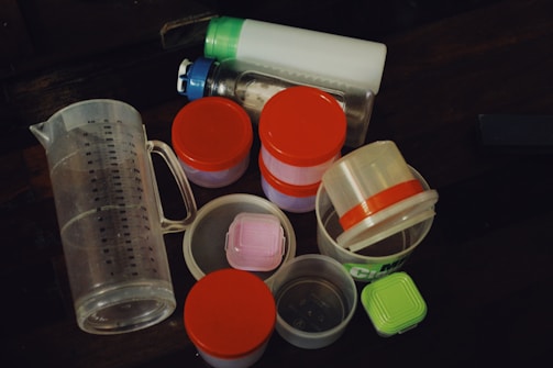 a table topped with plastic containers and containers