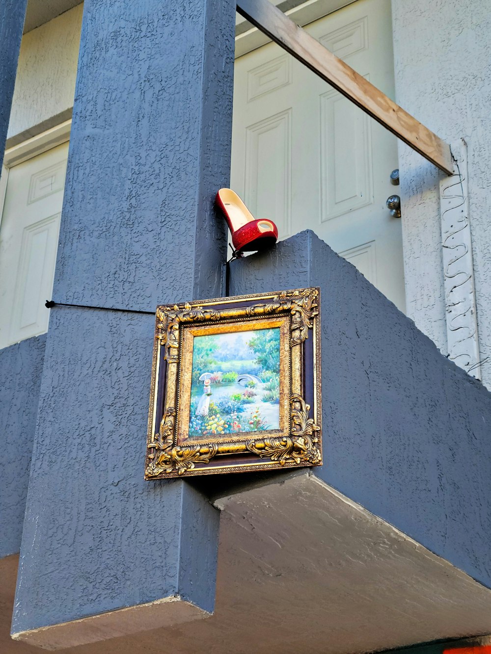 a painting hanging on the side of a building