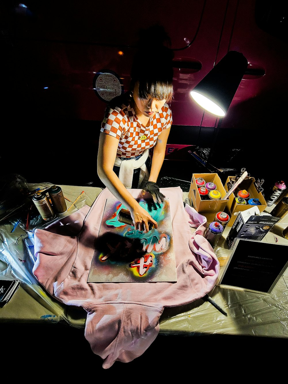 a woman is cutting a cake on a table