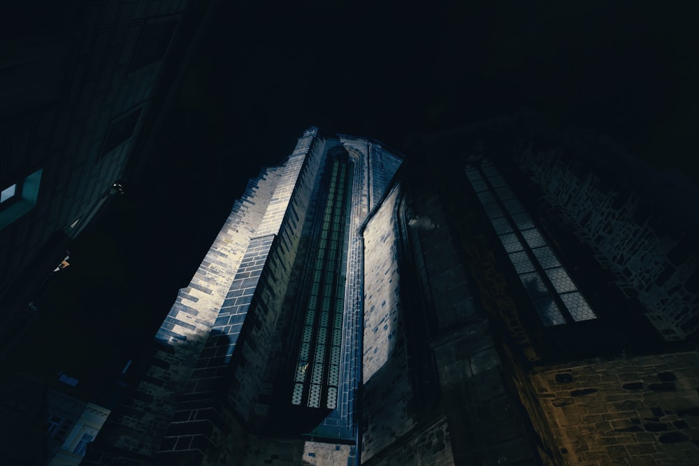 looking up at a tall building at night