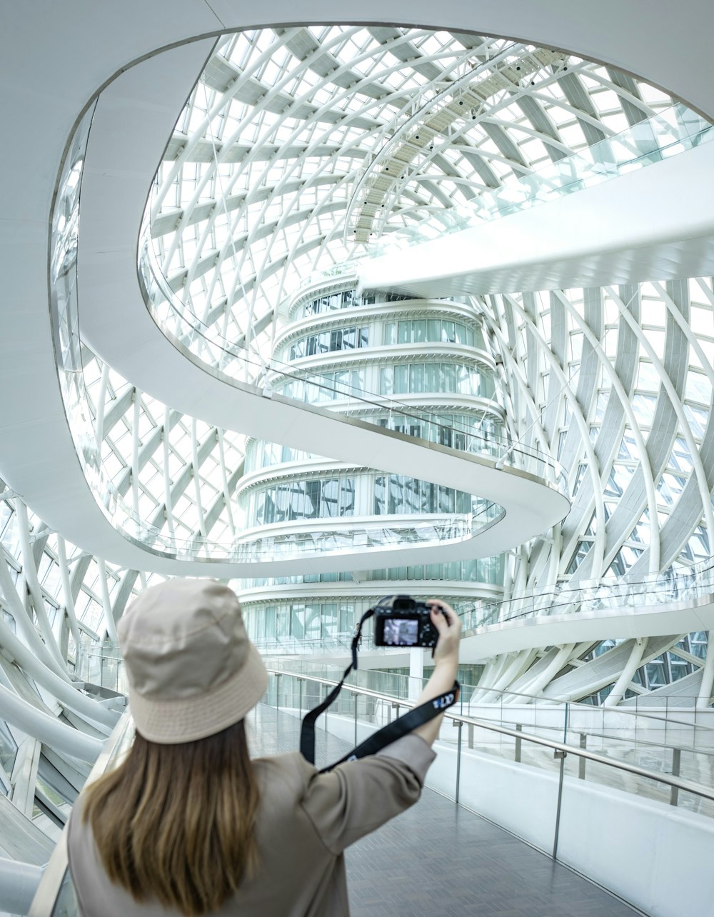 a woman taking a picture of a building with a camera