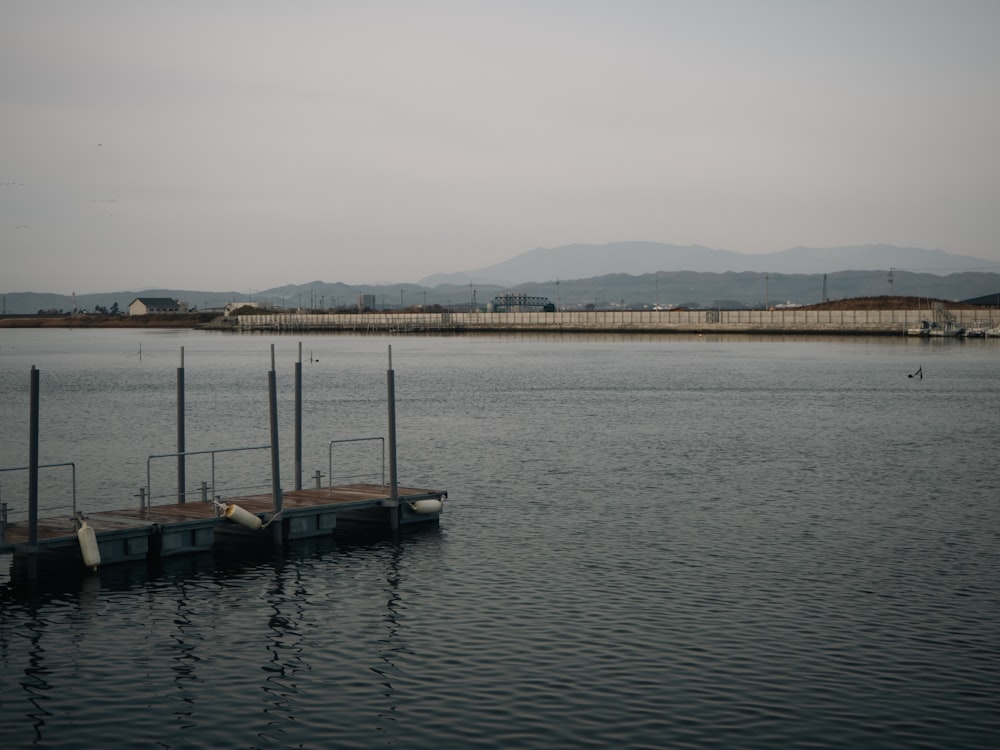 a body of water with a dock in the middle of it