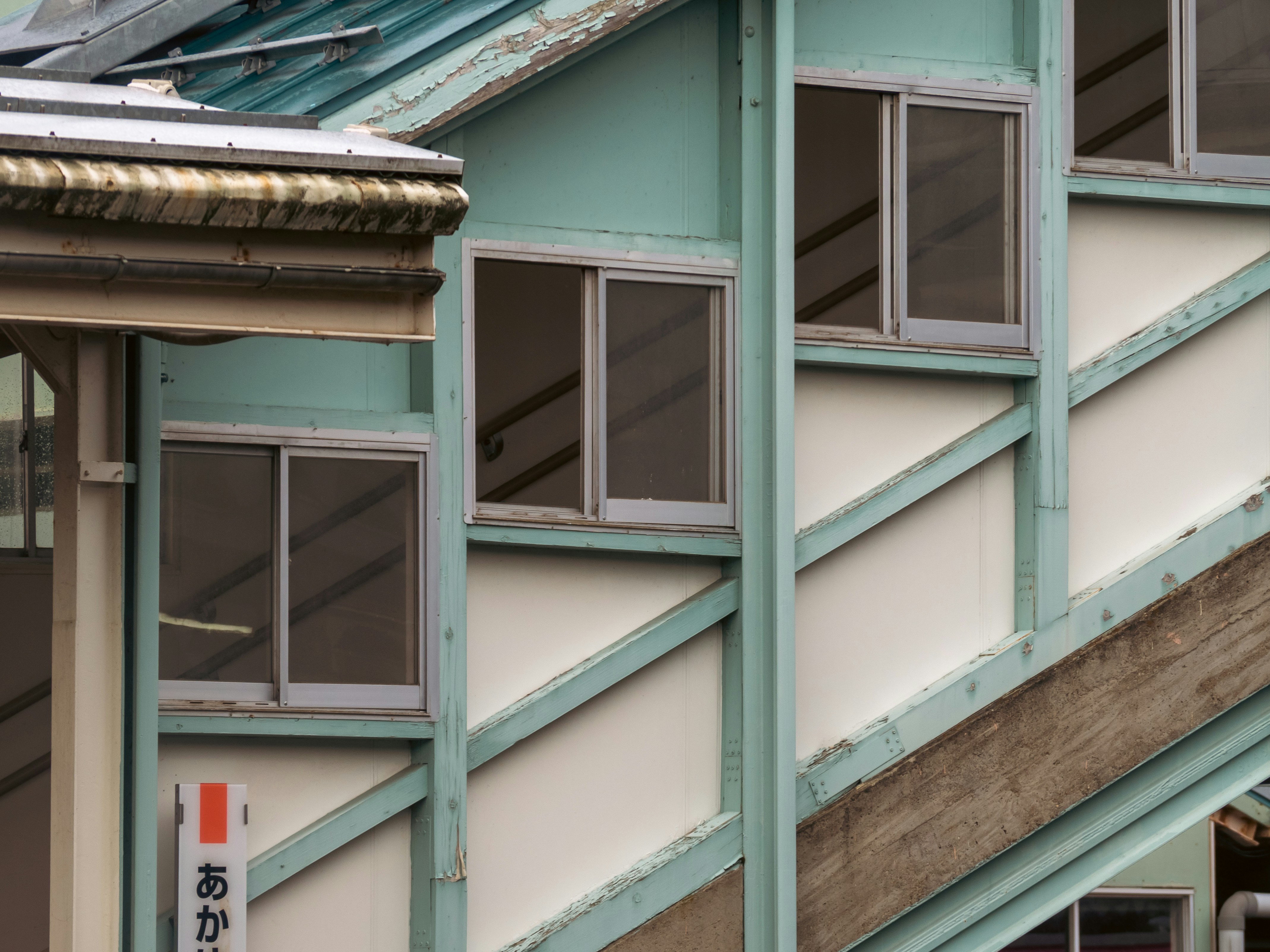 Person applying clear window insulation film to a Japanese apartment window