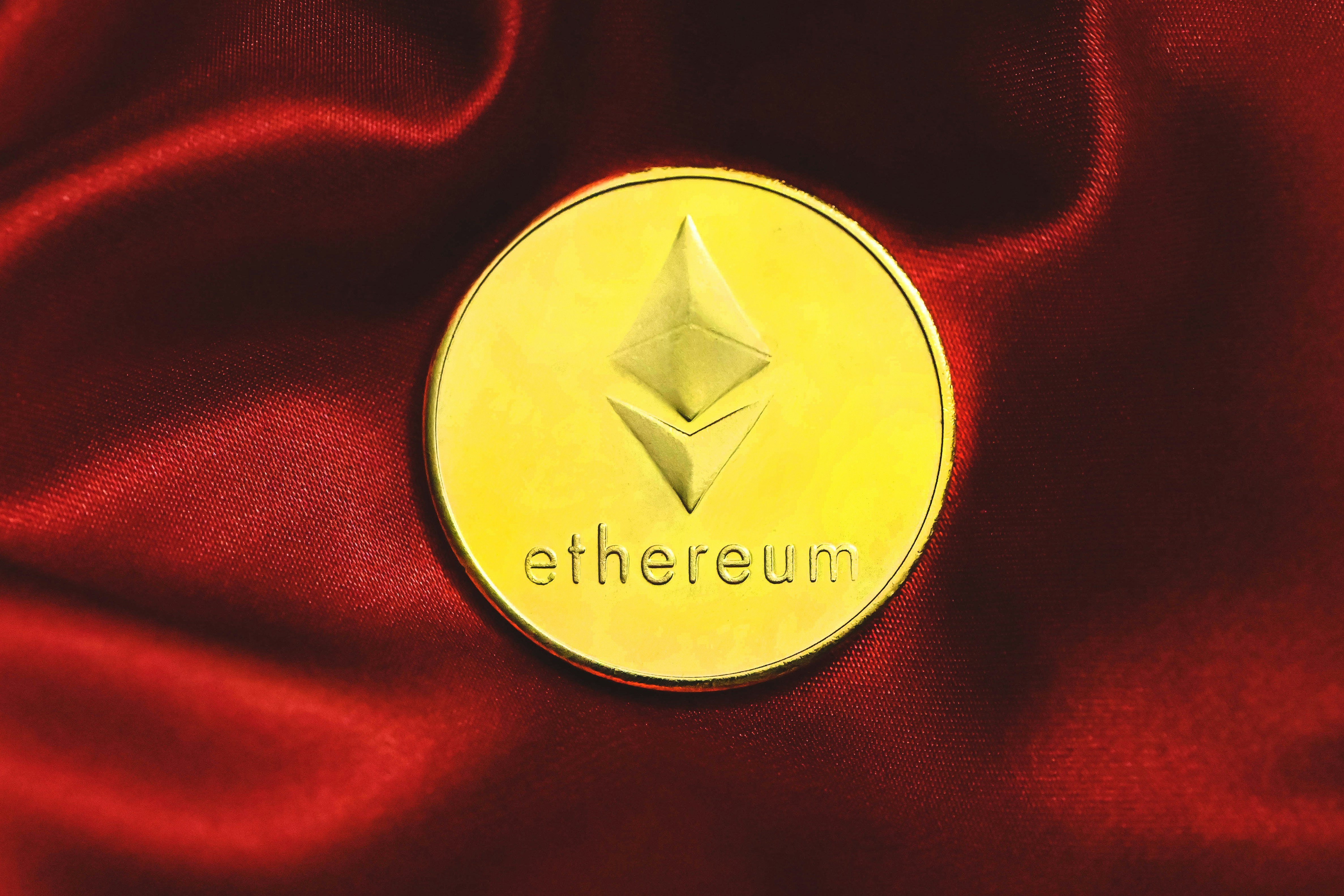 An Ethereum coin on red fabric
