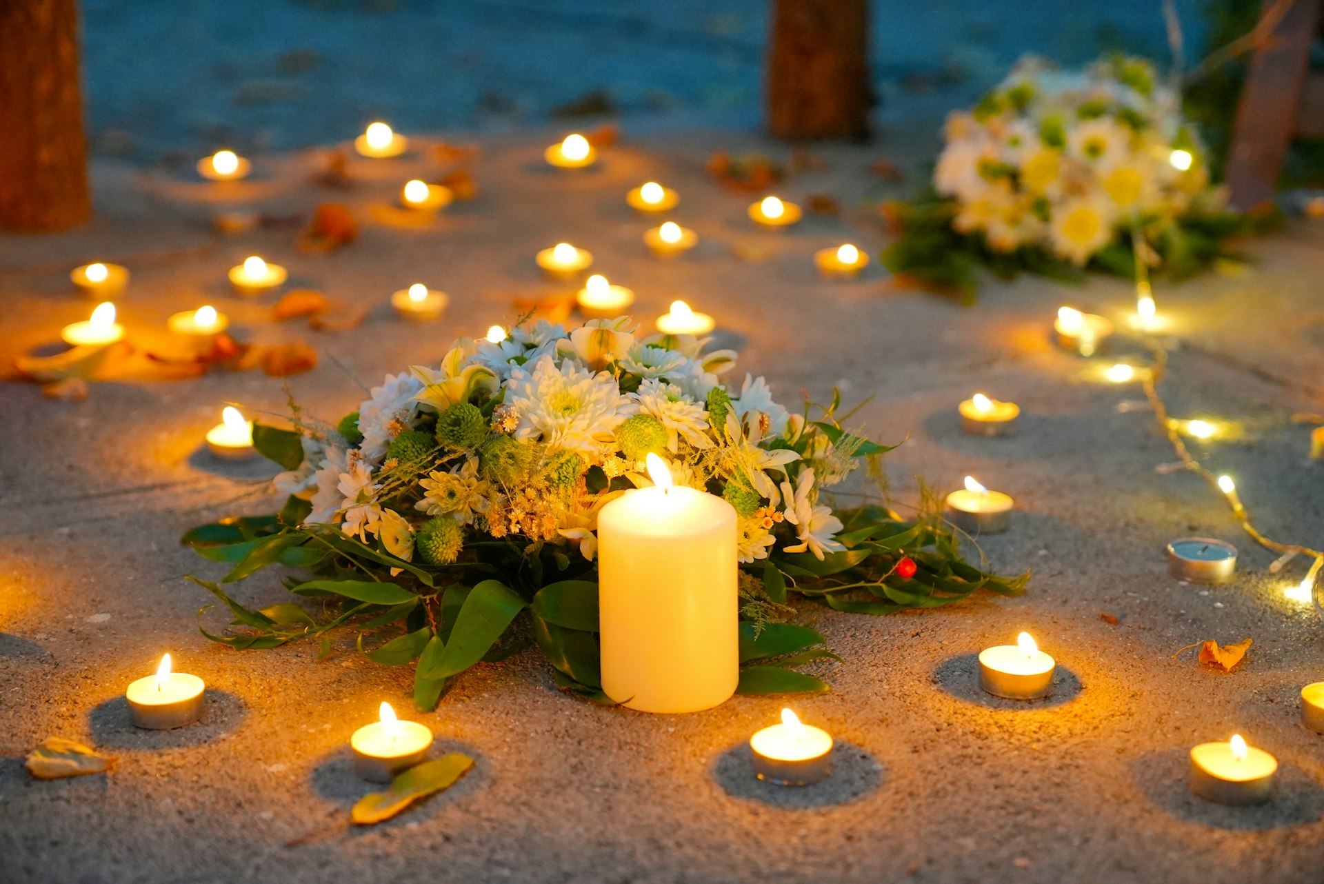 Beautiful candles and flowers on the ground