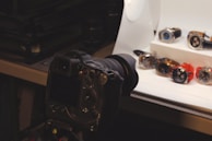 a camera is sitting on a tripod in front of a display of watches