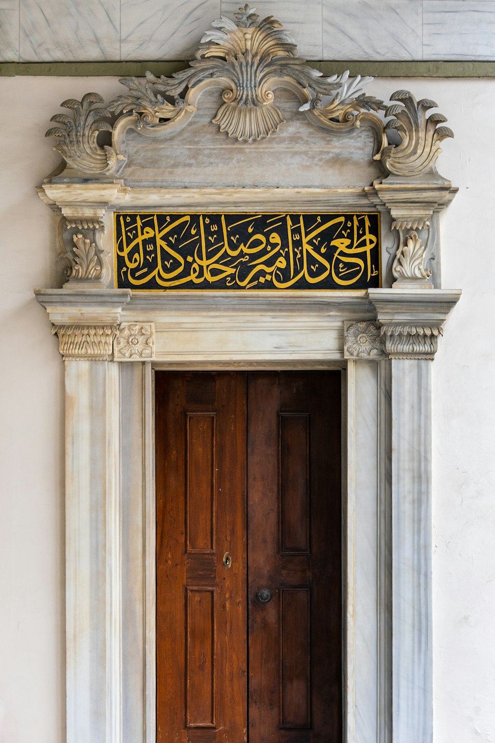 a large wooden door in a white building