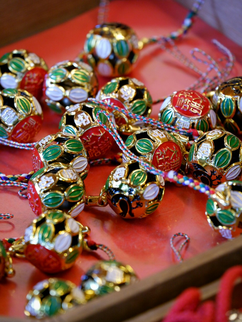 a red tray with a bunch of colorful beads on it