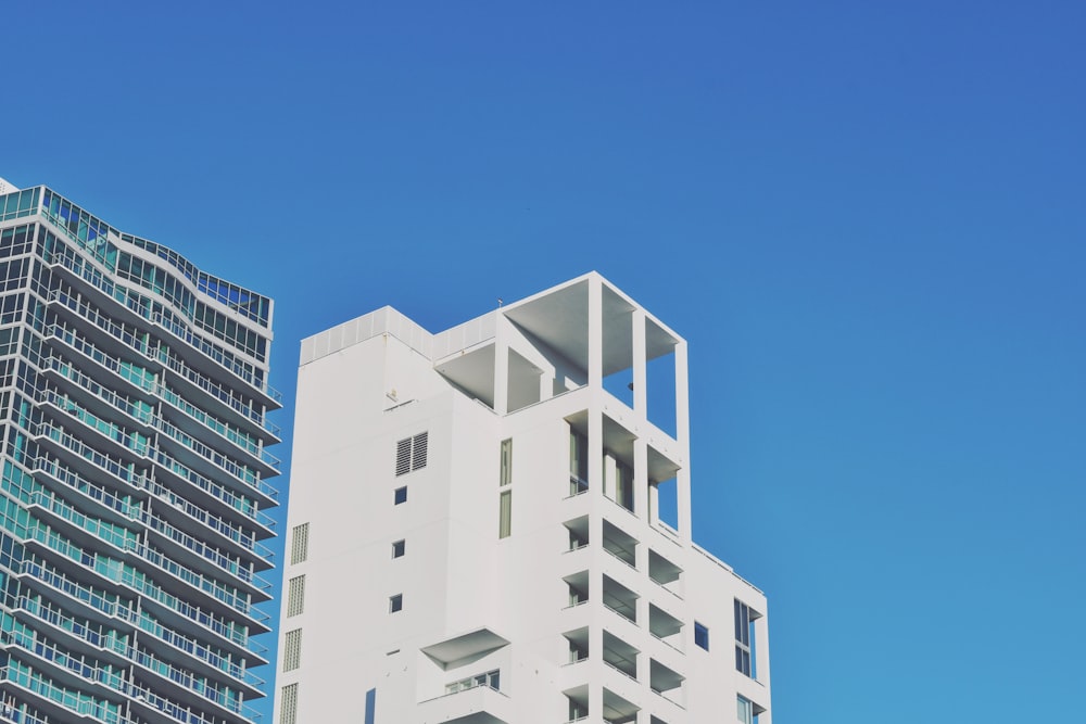 a tall white building sitting next to a tall white building