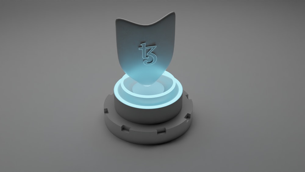 a blue illuminated object on a gray surface