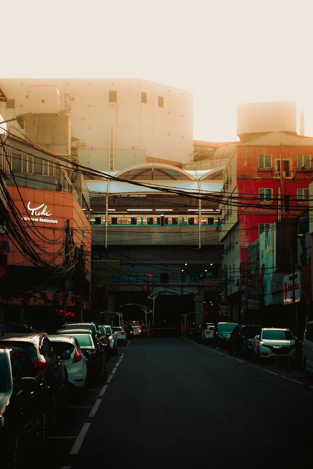 a city street filled with lots of traffic next to tall buildings