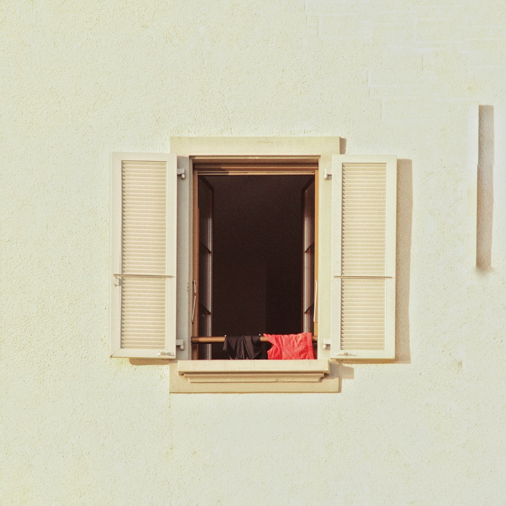 a person sitting at a table looking out of a window