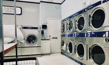 A modern self-service laundry facility with washing machines.