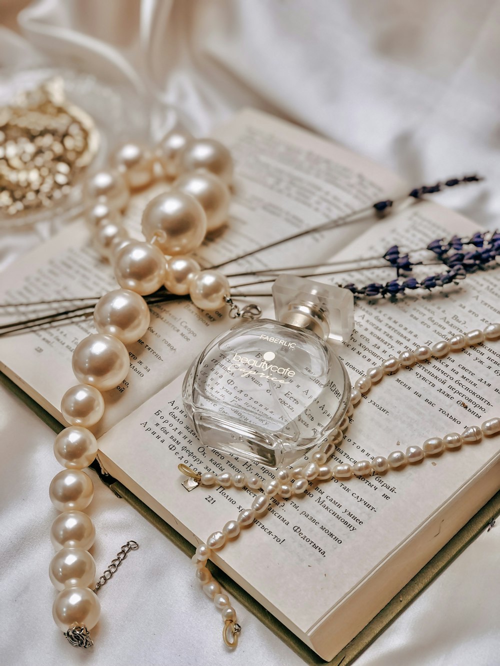 a book with pearls and a necklace on it