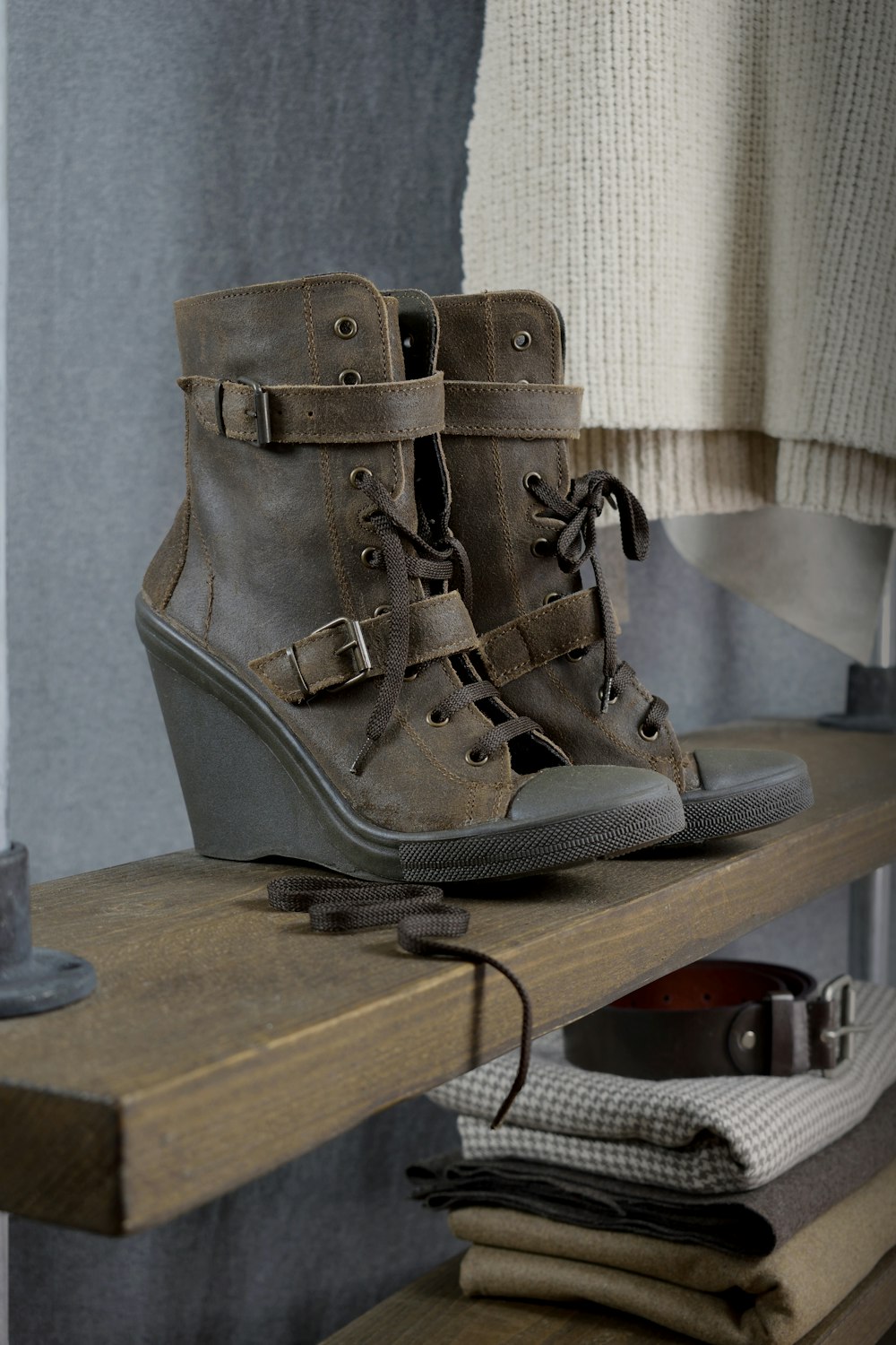 a pair of shoes sitting on top of a wooden shelf