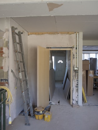 Interior view of a modern room undergoing renovation with fresh paint and new drywall installation