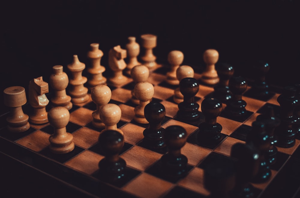 a close up of a chess board with pieces on it