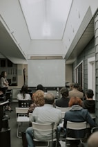 a group of people sitting in chairs in a room