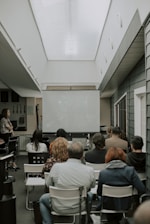 a group of people sitting in chairs in a room