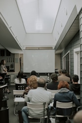 a group of people sitting in chairs in a room