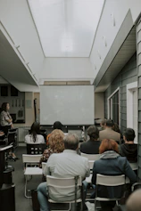 a group of people sitting in chairs in a room