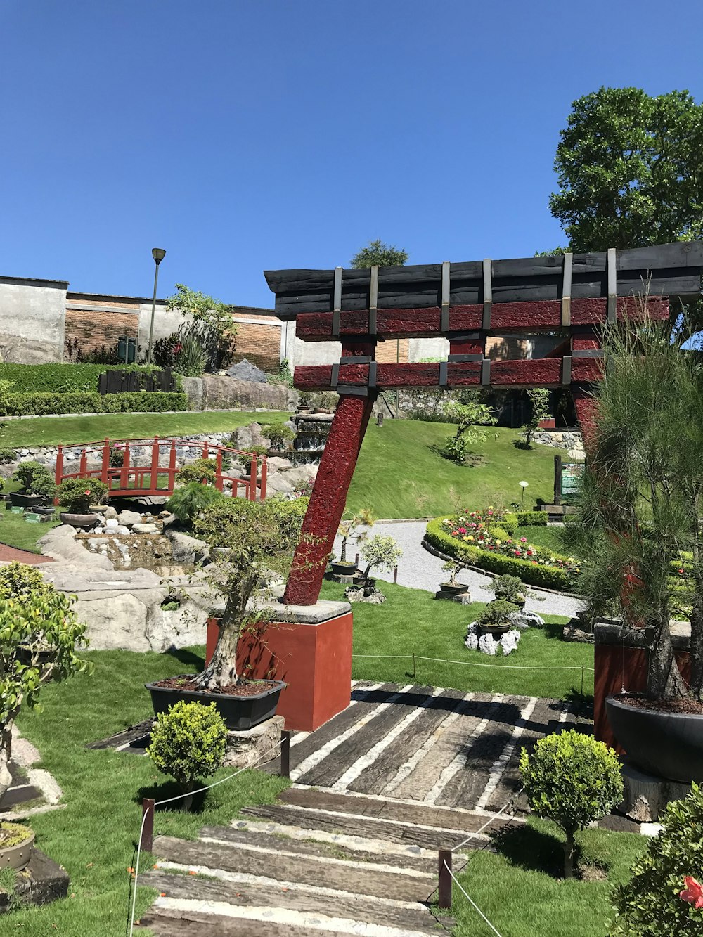 a garden with steps leading up to a bridge