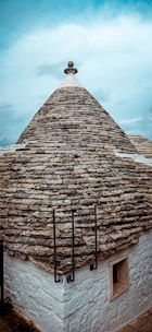 Exterior view of the Trullo with its characteristic stone cone roof and small window.