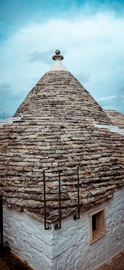 Exterior view of the Trullo with its characteristic stone cone roof and small window.