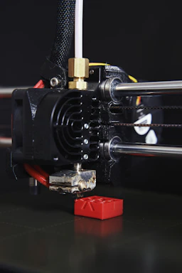 Close-up image of a 3D printer in action creating a detailed vase with vibrant colors.