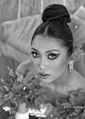 Portrait of a model with bold eye makeup and sleek hair.