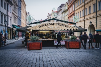 a small market stand on a cobblestone street