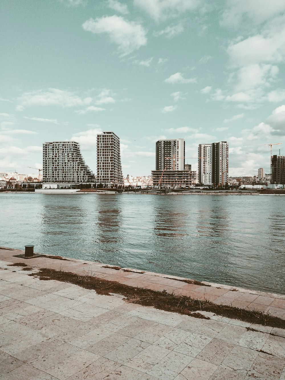 a large body of water with a city in the background