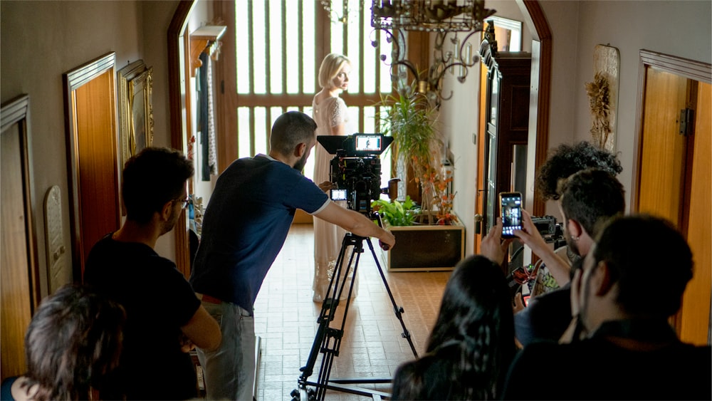 a man and a woman standing in front of a camera