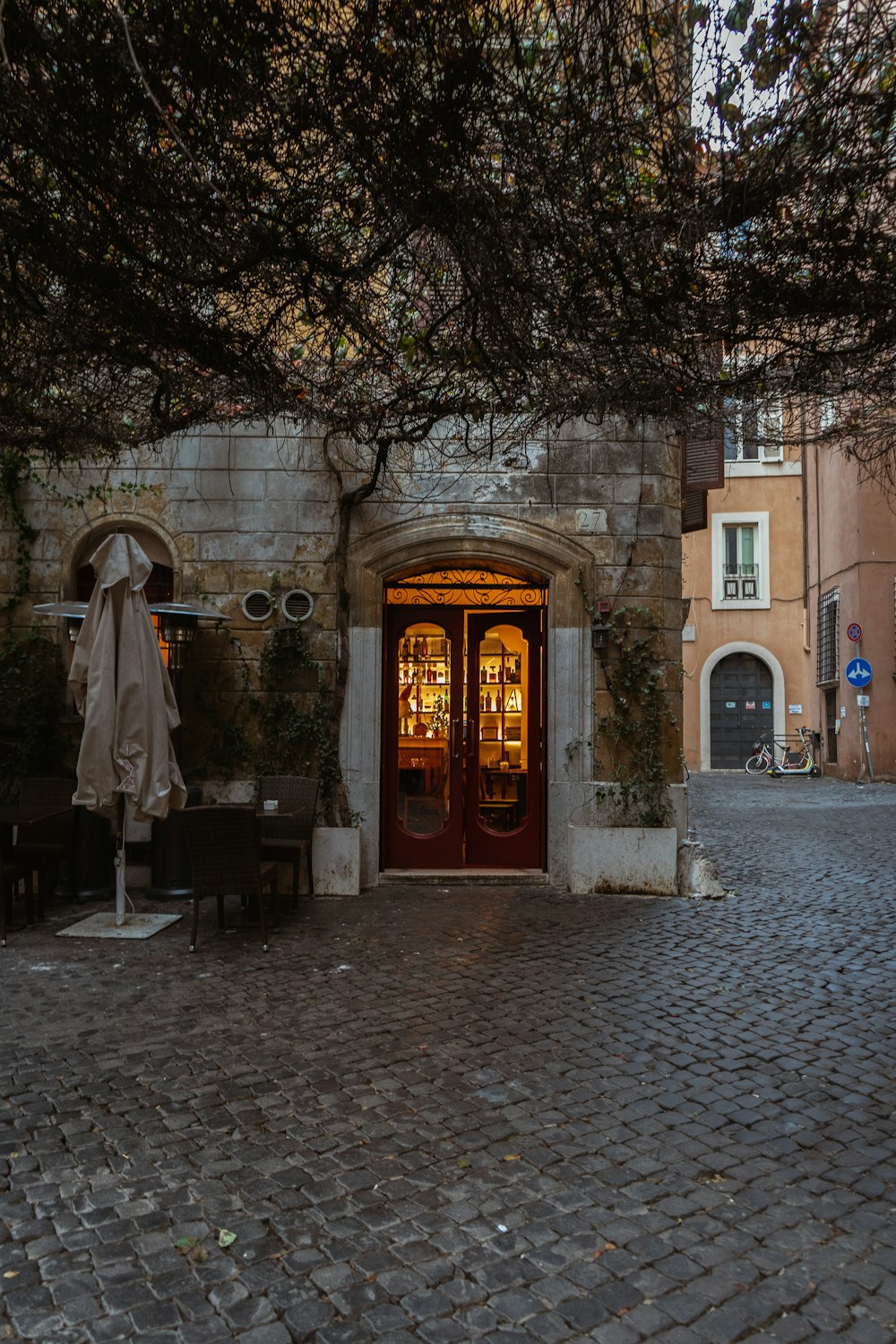 a cobblestone street with a restaurant entrance