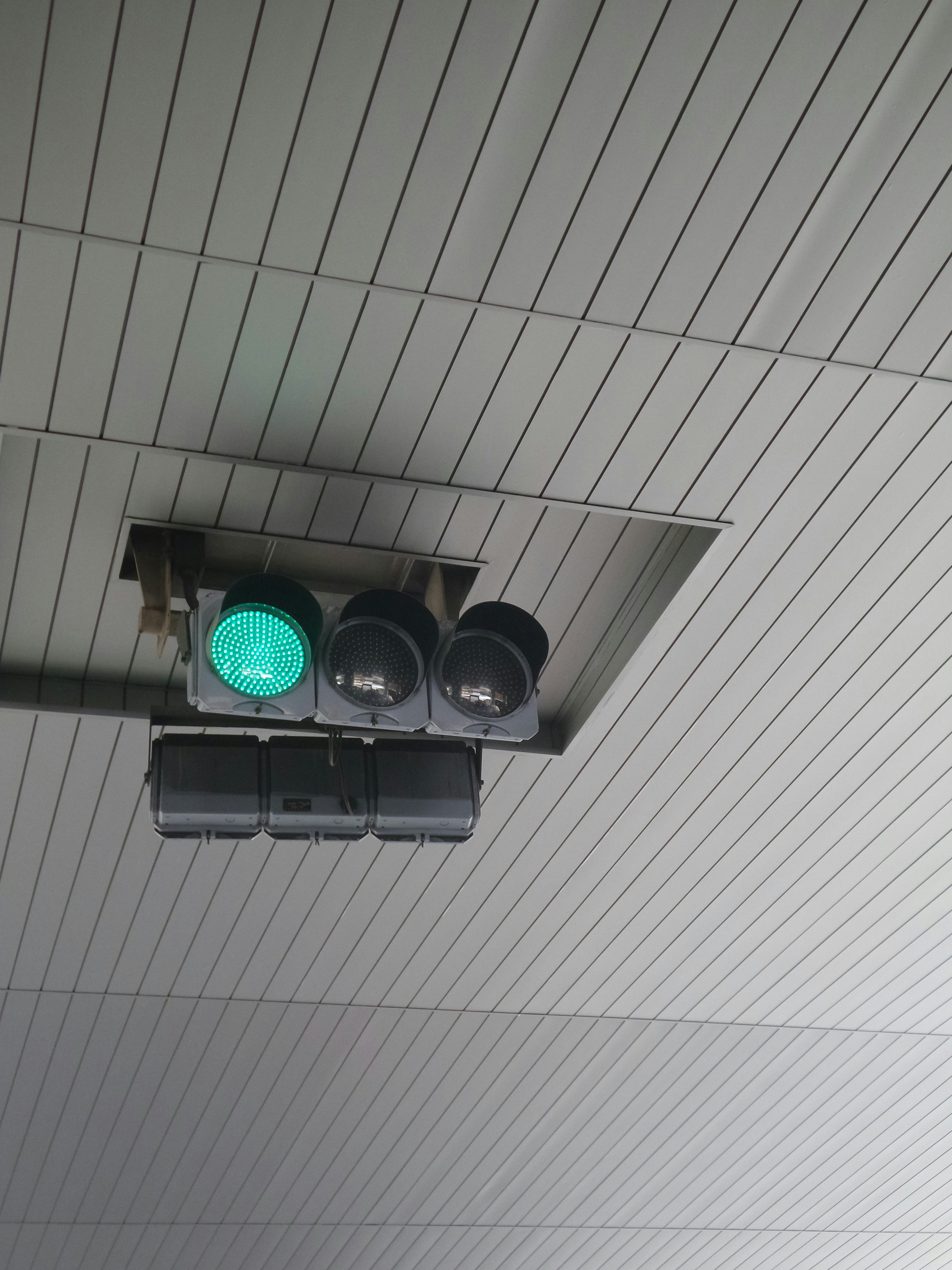 a traffic light hanging from the ceiling of a building