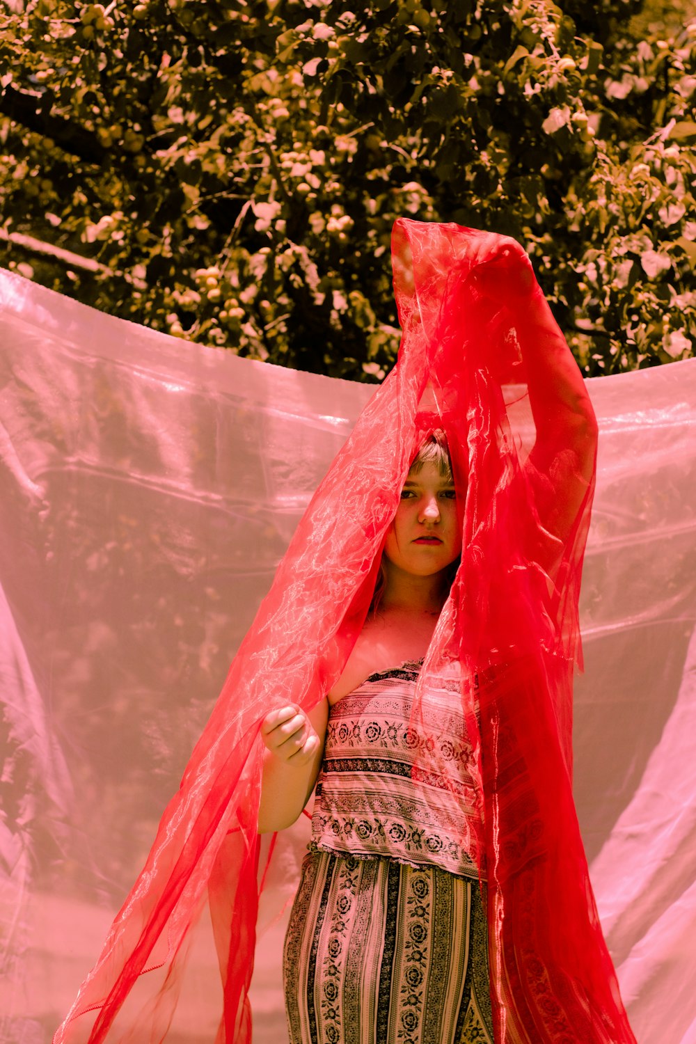 a woman with a red scarf around her head