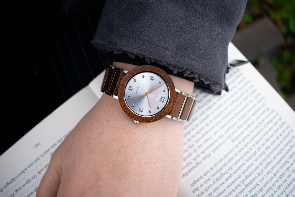a person wearing a wooden watch on their wrist