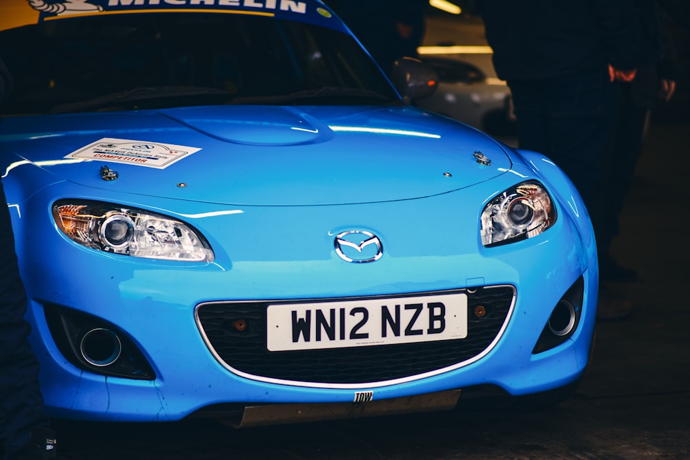 a blue sports car parked in a garage