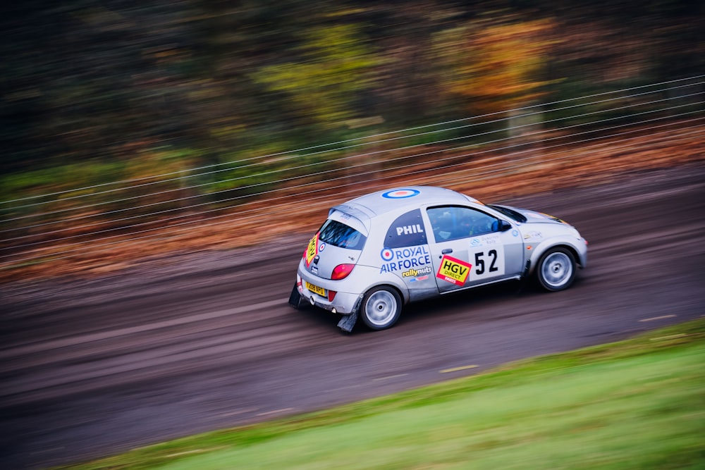 a small car driving down a race track