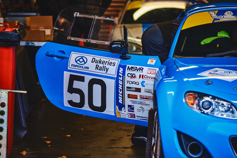 a blue car with a number plate on it