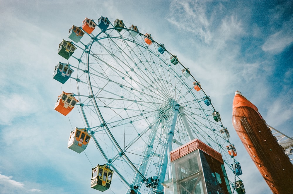 a large ferris wheel sitting next to a tall building