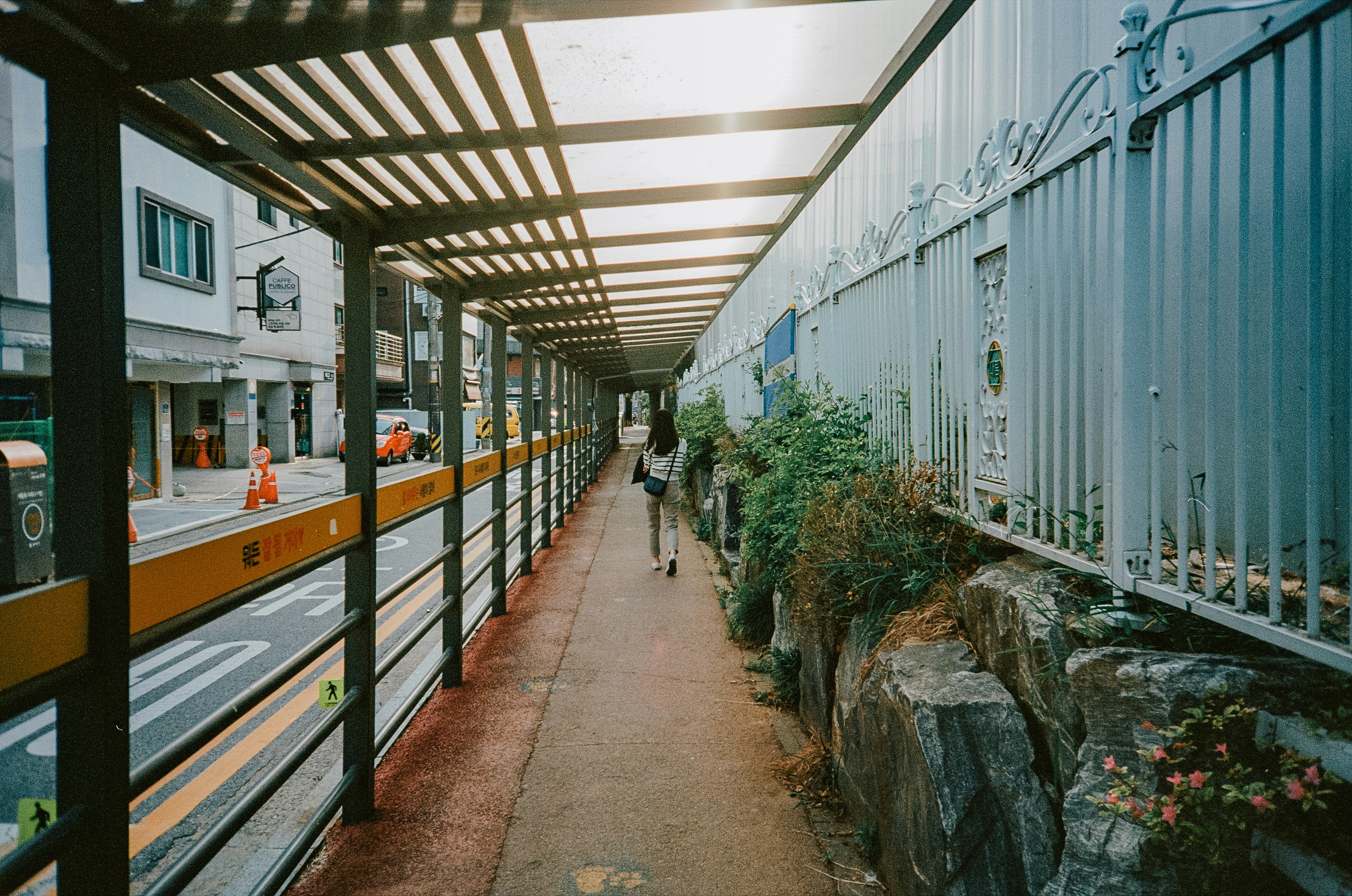 a long walkway with a train on the side of it