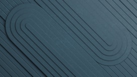 A geometric pattern featuring a series of parallel lines and rounded shapes embossed into a textured surface. The design emphasizes symmetry and balance, with the lines curving smoothly to form looped structures.