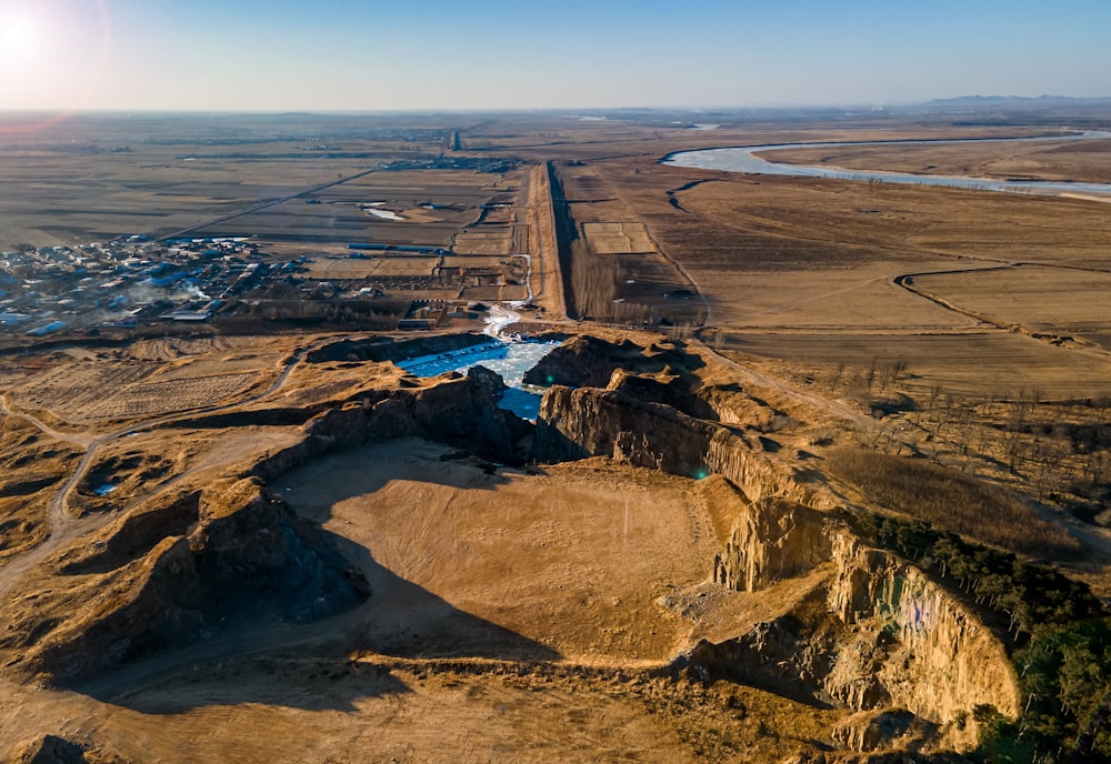 an aerial view of a road and a body of water