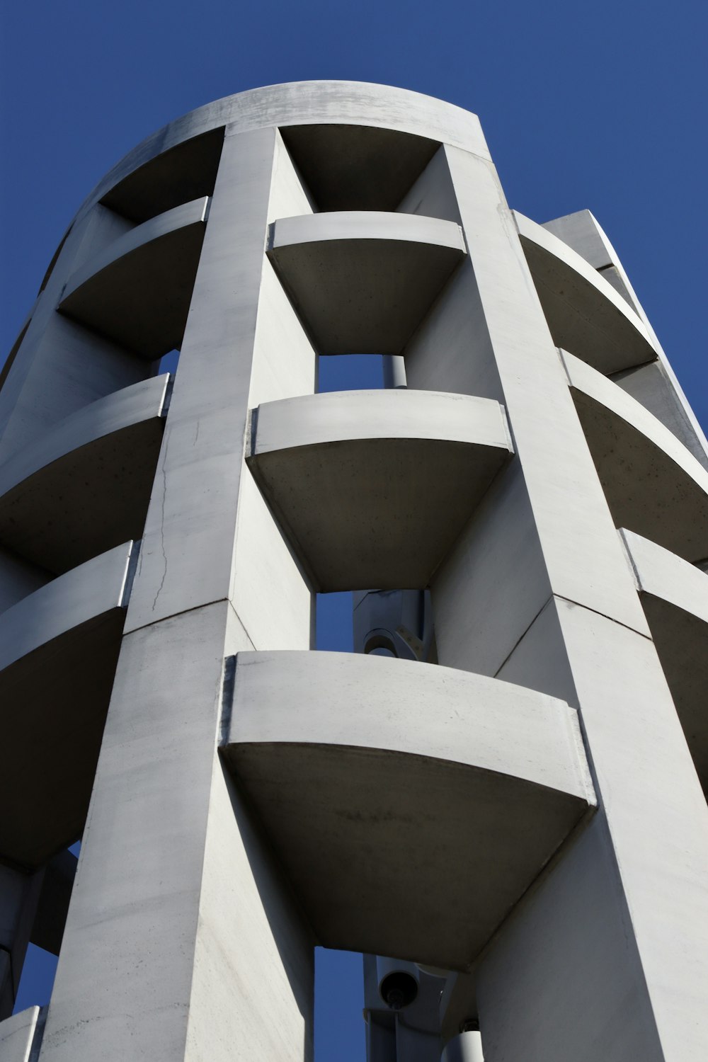 a tall white building with a sky background