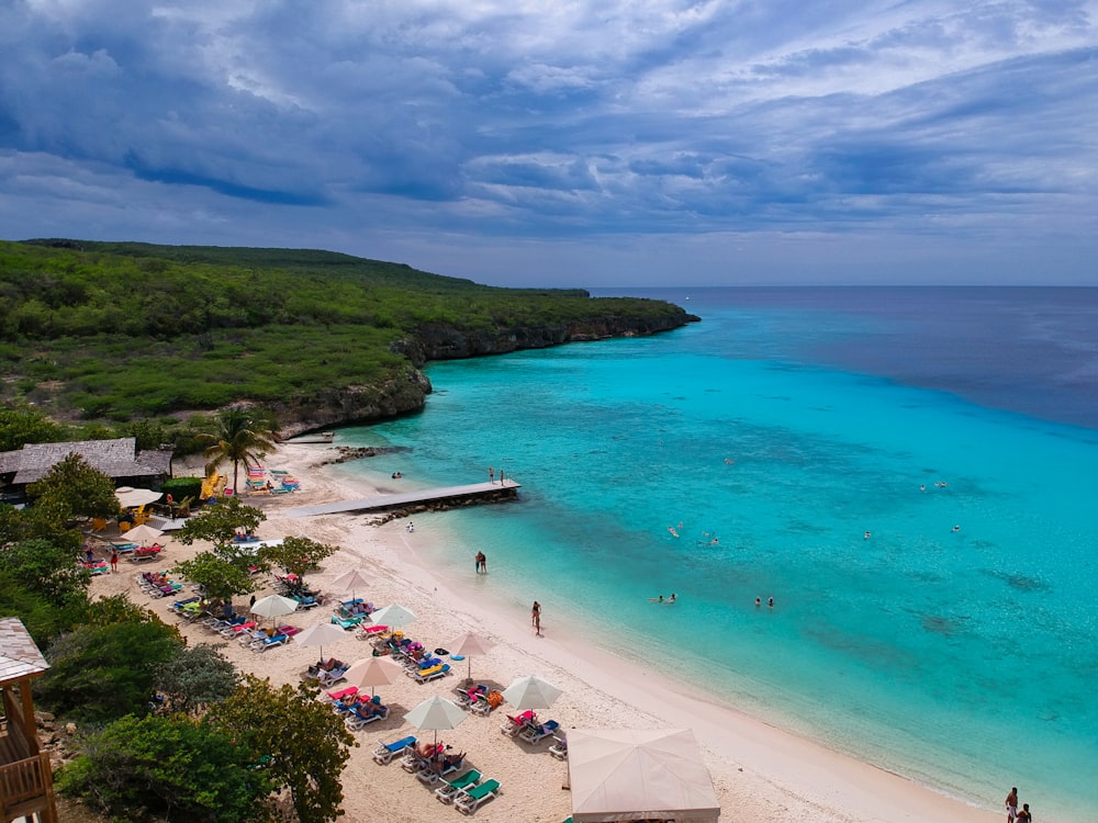 a beach that has a lot of people on it