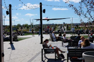 Families enjoying live music and cultural storytelling in a sunny outdoor festival setting.