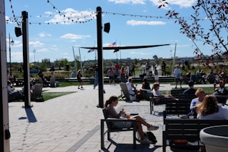 Families enjoying live music and kids’ activities in a sunny outdoor market setting.