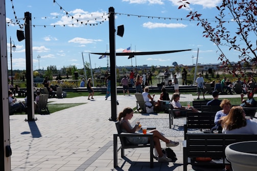 A lively outdoor arena filled with families enjoying a sunny day.